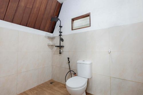a bathroom with a toilet and a shower at Villa Platinum 2 in Banjarnegara