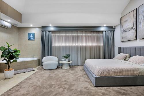 a bedroom with a bed and a bath tub at Lakeside Serenity in Hindmarsh Island