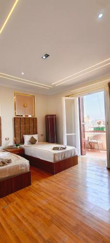 a bedroom with two beds and a large window at swiss hotel cairo downtown in Cairo