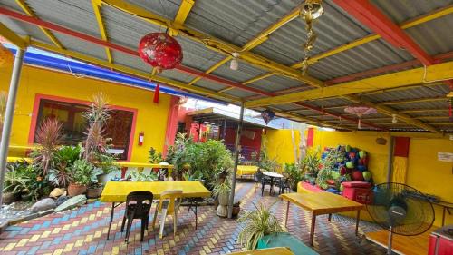 a patio with a table and chairs and plants at Buku Island House in san juan la union