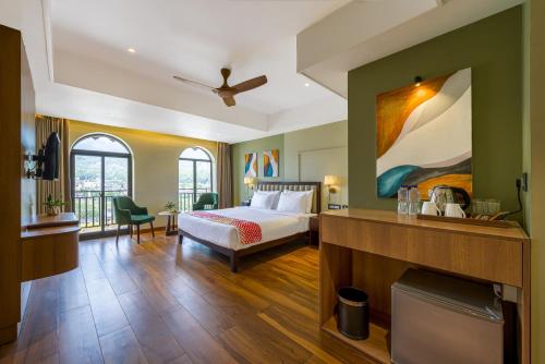 a hotel room with a bed and a fireplace at Ginger Rishikesh, Dehradun Road in Rishīkesh