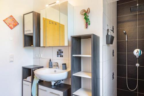 a bathroom with a sink and a shower at Die Gemütliche Fewo in Breitenberg