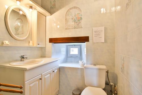 a bathroom with a toilet and a sink at Manoir De Labelangerie in Acqueville