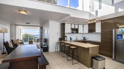 an open kitchen with a counter and a dining room at The Lookout in Woorim