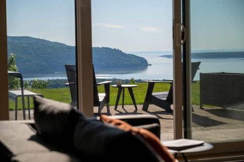 a room with a window with a view of the water at 102 - Upscale Condo - River View Terrace in Baie-Saint-Paul
