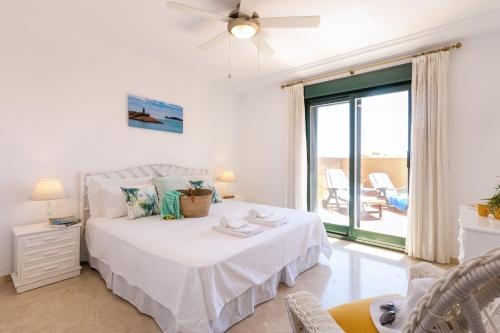 a bedroom with a bed with a window and a patio at Floridamar Mimosa in Jávea