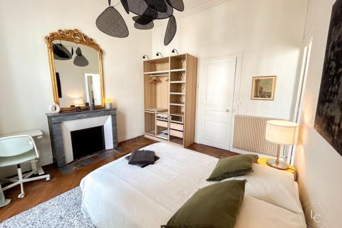 a bedroom with a white bed and a mirror at La Cathédrale - 47 m2 - 1 bedroom in Orléans