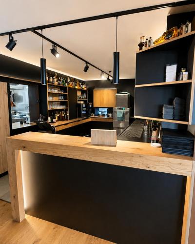 a kitchen with a wooden counter in a room at Hotel Weinhaus Wiedemann in Ginsheim