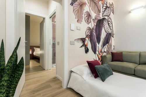 a living room with a couch and a painting on the wall at GuestHost - Vivaldi Autunno Apartment in Treviglio