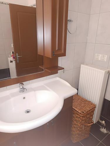 a bathroom with a white sink and a mirror at Gialova Relax in Korifásion