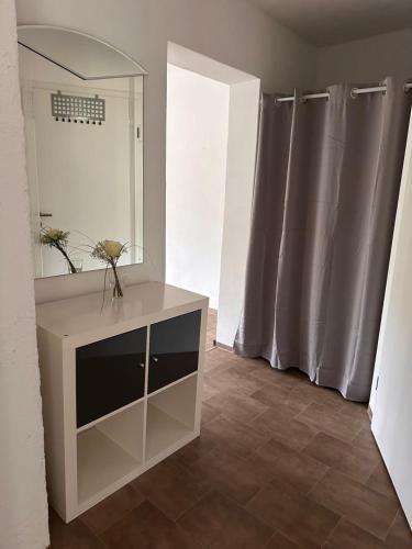 a bathroom with a vanity with a mirror and curtains at NEU! Kleines Glück Illingen in Illingen