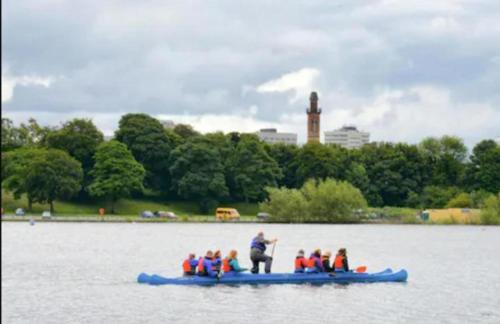 a group of people on a blue raft in the water at Budget Central Birmingham in Birmingham