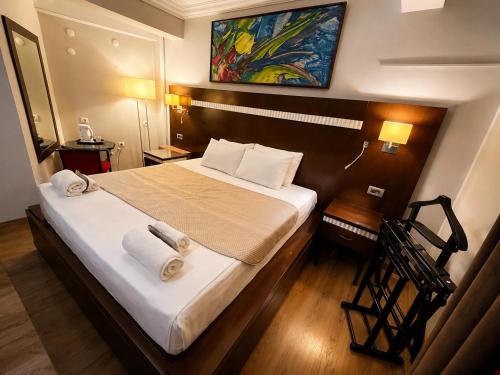 a bedroom with a large bed with towels on it at Mola INN Uşak in Uşak