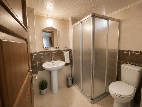 a bathroom with a shower and a toilet and a sink at Mola INN Uşak in Uşak