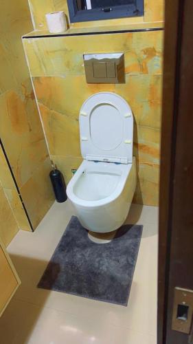 a bathroom with a toilet in a room at The Abode in Lekki Phase 1