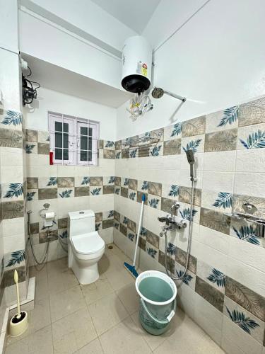 a bathroom with a toilet and a shower at Tre Lum Homestay in Jowai