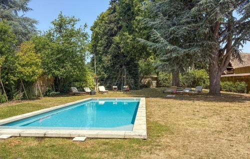 a swimming pool in the yard of a house at Lovely Home In Clef Vallée D'eure in La Croix-Saint-Leufroy