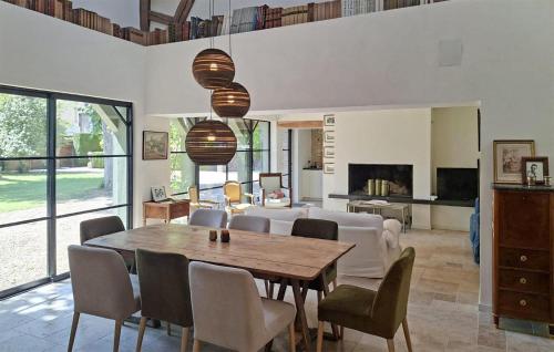 a living room with a table and chairs and a couch at Lovely Home In Clef Vallée D'eure in La Croix-Saint-Leufroy