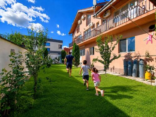 a group of people walking in the grass at Pensiunea Rozeclas in Sînmartin