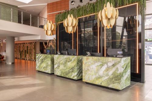 a lobby with a long counter in a building at Savhotel Mantegna Padova in Padova