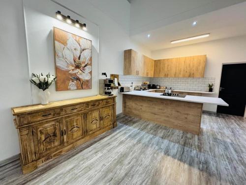 a large kitchen with wooden cabinets and a counter at Carlo's Fairview Boutique - Hotel in Walvis Bay
