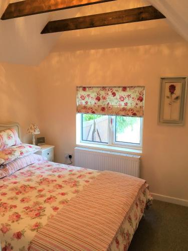 a bedroom with a bed and a window at Fring House Apartment in Seaton