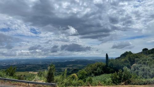 a view of a valley under a cloudy sky at Casa Le Campane sulla Via Francigena in Gambassi Terme