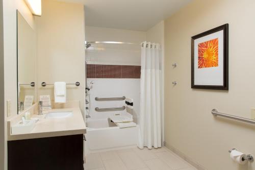 a bathroom with a sink and a shower at Staybridge Suites Corona South, an IHG Hotel in Corona