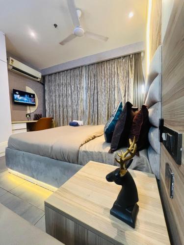 a hotel room with two beds and a television at Supernova luxe heaven in New Delhi