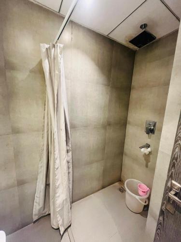 a bathroom with a shower curtain in a room at Supernova luxe heaven in New Delhi