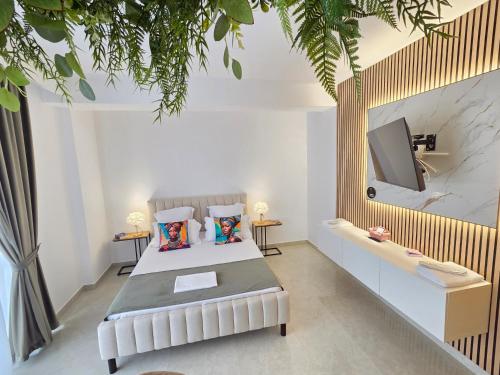 a bedroom with a bed and a flat screen tv at Chic 2 Chic Boutique in Bucharest