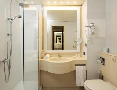 a bathroom with a sink and a shower and a toilet at Best Western Park Hotel in Piacenza