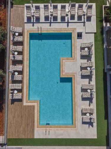 an overhead view of a swimming pool with lounge chairs at Filia Luxury Suites in Stalís