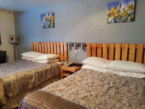 a hotel room with two beds and a table at Soldotna Inn in Soldotna