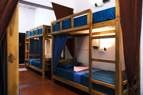 a bunk bed room with two bunk beds in it at Wonder Surf Hostel in Arugam Bay