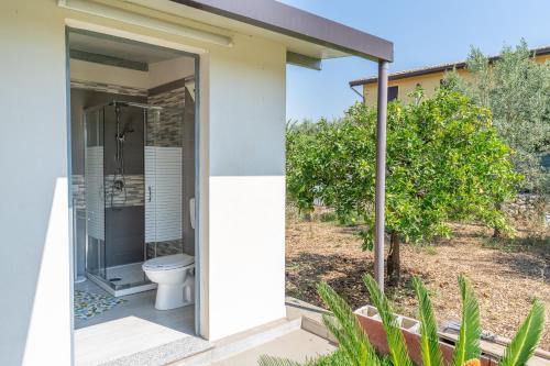 a bathroom with a toilet outside of a house at Villa Caterina in Solarino