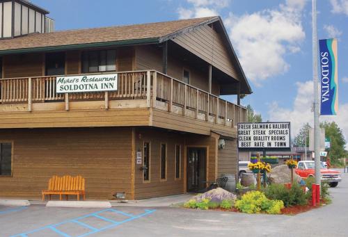 a building with a sign that reads masterplanned subdivision inn at Soldotna Inn in Soldotna