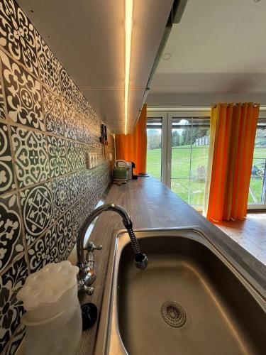 a kitchen with a sink with a faucet at Apartmány2 - Náhlov in Frymburk