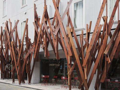 a group of wooden structures on the side of a building at ONE@Tokyo by insomnia in Tokyo
