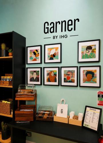 a room with pictures on a wall with a shelf at Garner Hotel Dublin Temple Bar by IHG in Dublin