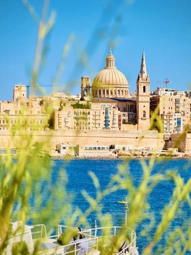 a view of a city from the water with a building at Prime Located Home by *The Sea* in Sliema
