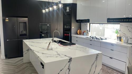 a kitchen with a white counter top and a stove at Ballarat home in Ballarat