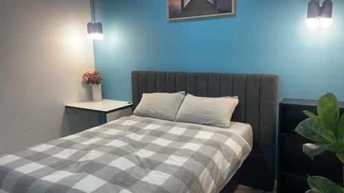 a bedroom with a bed with a checkered blanket at Ballarat home in Ballarat