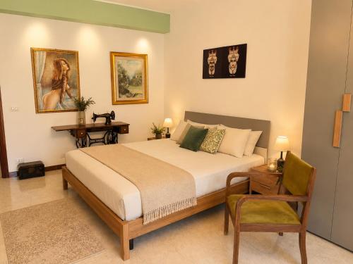 a bedroom with a bed and a desk and a chair at Flavia's House in Gaggi