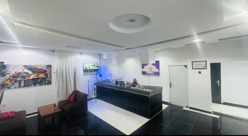 a lobby with a reception desk in a building at Pandorax Hotel Oluku in Benin City