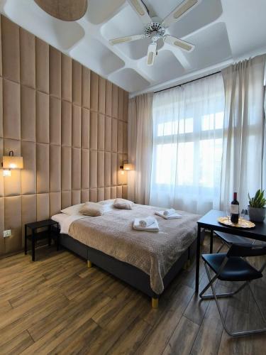 a bedroom with a bed and a ceiling fan at Place4You Studio w Sercu Ostródy in Ostróda