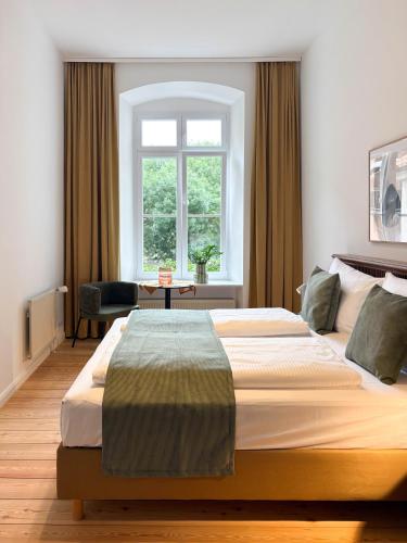 a bedroom with a large bed and a window at Apartments am Alten Markt in Stralsund