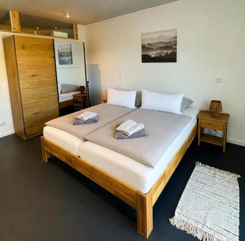a bedroom with a large bed with two towels on it at Hollender Hof in Bongard