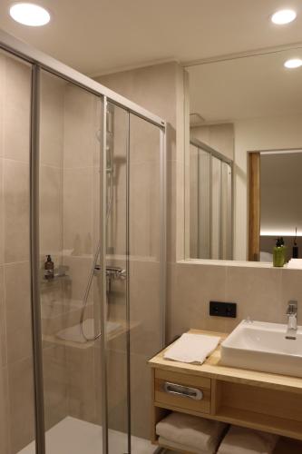 a bathroom with a shower and a sink at Haus der Achtsamkeit in Grünau im Almtal