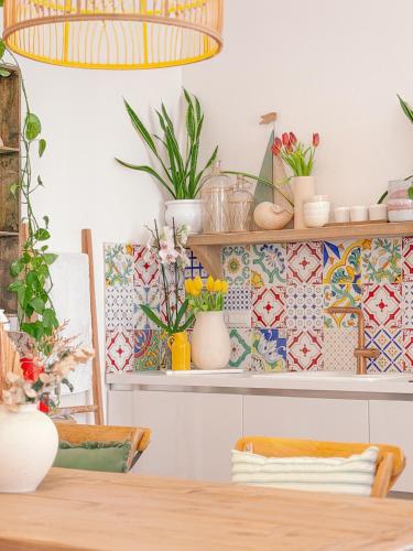 a dining room with a table and plants on shelves at Indarsena b&b in Portoferraio